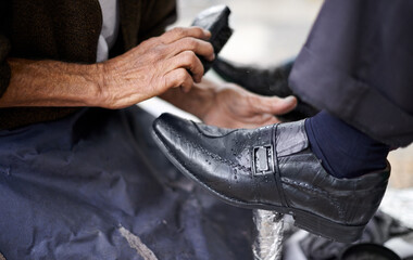 Fototapeta premium Street, polish or hands of man with shoes in cleaning service in city for shining with wax, trade and job. Closeup, customer or person with brush in downtown for business, footwear or outdoor help