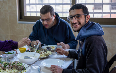 males eating mansaf on dinner