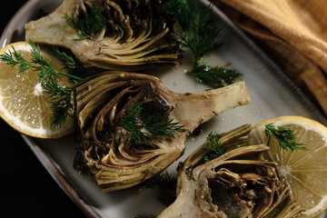 baby artichoke cooked with olive oil and greens, popular springtime mediterranean kitchen starter...