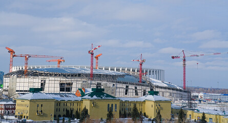 Panoramic view of a large urban construction site with a large number of cranes.