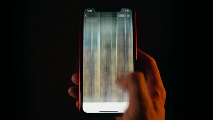 Close-up time-lapse of male hand scrolling social networks on smartphone screen, network scroll mobile phone screen at night, blurred fast motion, pov cellphone scrolling apps surf internet web pages - Powered by Adobe