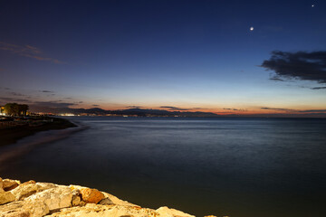 View from Torremolinos towards Malaga just before sunrise. Costa del Sol, Spain. - obrazy, fototapety, plakaty