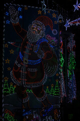 LED light Santa clause against black background.