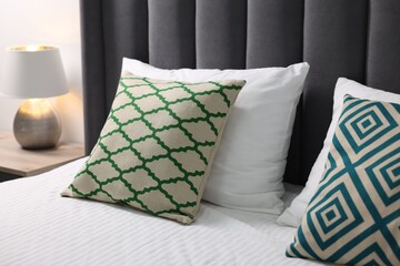 Soft pillows and bedsheet on bed at home