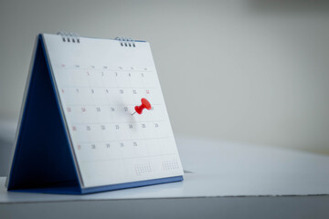 Mark on calendar white paper desk calendar with drawing-pins appointment and business meeting concept