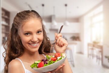 Happy young lady eating homemade dish