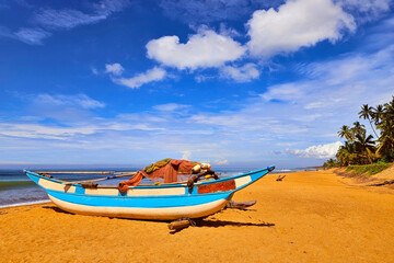 Fishing boat on sand of Waskaduwa beach, Sri Lanka. - 752280524