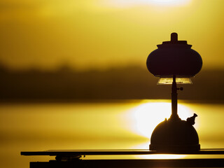 Light an oil lamp at dusk in the swamp.