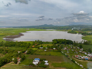 Tropical landscape with lake surrounded by greenery trees. Bukidnon, Philippines. Mindanao.