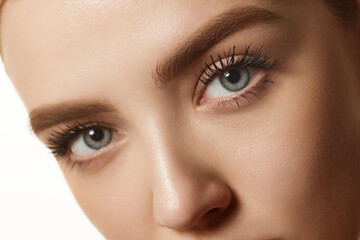 Naklejka premium Close-up of beautiful female face isolated against white studio background. Model with well-kept, spotless, smooth skin. Concept of natural beauty, cosmetology, cosmetics, skin care and health