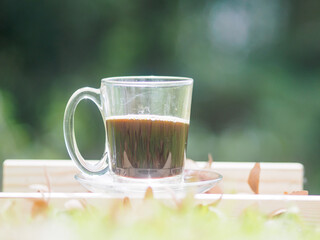 Fresh coffee ready to drink on the grass