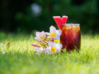 Mixed coffee decorated with herbs and fruits on the lawn