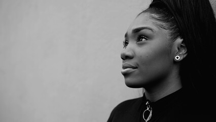 One peaceful contemplative young black woman gazing at sky in tranquility and quiet meditation in...