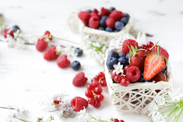 fresh berries raspberries strawberries currants on a wooden table