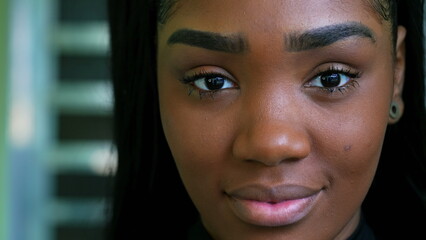 One young black latina adult girl from South American staring at camera with positive emotion....