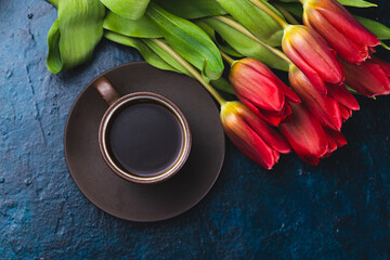a cup of coffee and a bouquet of tulips