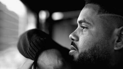 Pensive Young Man Lost in Thought - Dramatic Monochrome Black and White Portrait of Introspective Hispanic Black 20s Individual