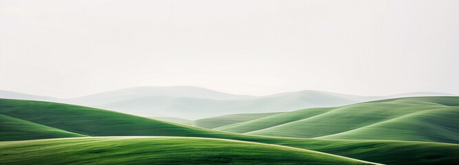 Rolling green hills under a clear sky, showcasing nature’s serene beauty, ideal for backgrounds or peaceful scenery visuals in designs and displays.