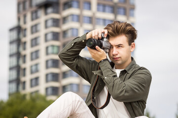 The guy looks at the camera and takes pictures