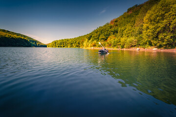 Trip on the river by canoe. Calm summer view of Dnister river, Ukraine, Europe. Splendid morning scene of green foliage forest on the mountain canyon. Traveling concept background..