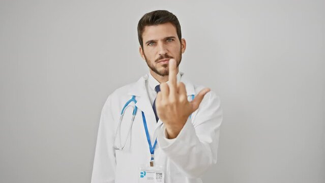 Angry young hispanic guy with a stethoscope showing the naughty 'fuck you' sign. rude and impolite expression of a bearded doctor giving a crazy stop sign against a white, isolated background.
