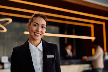 Portrait of happy female concierge in hotel looking at camera.