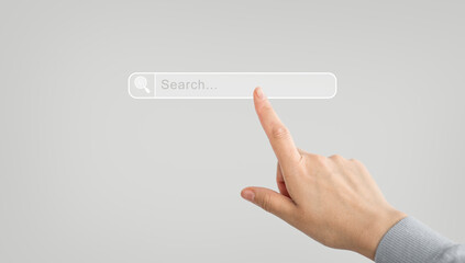 Concept of searching, browsing data and sharing information online. Hand clicking on an Internet search page on a computer touch screen. Finger presses the screen to search. Online browser user.