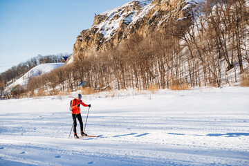 Enjoying cross country skiing on a frozen lake under the sky