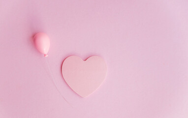 Pink heart sticky note on pink background with copy space 