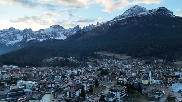 Aerial drone view Andalo town with mountains background in winter. Ski resort Paganella Andalo, Trentino-Alto Adige, Italy.Italian Dolomites Pagnella valley. Snow covered Italian Dolomites at winter.
