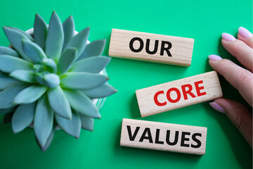 Our core values symbol. Concept words Our core values on wooden blocks. Beautiful green background...