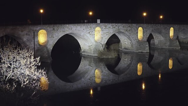 Illumination on Stone bridge on Duero river. Zamora is a city in Castile and Leon, Spain. Evening time.