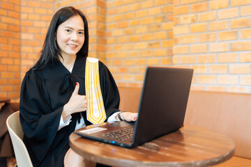 Asian female lawyer Raise your hand like symbol Wear a legal suit and submit a complaint to the prosecutor. Accept online legal matters via laptop for clients and defendants awaiting mediation. - obrazy, fototapety, plakaty
