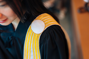 Close-up of a suit symbolizing justice of an Asian female lawyer smiling and deciding cases for clients and defendants waiting to mediate in the office of the Supreme Court. - obrazy, fototapety, plakaty