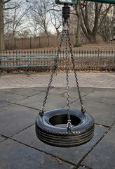 tire swing on metal chains in a public park (mount prospect park brooklyn new york city) urban...