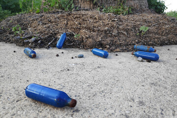 Nitrous Oxide canisters discarded on the pavement