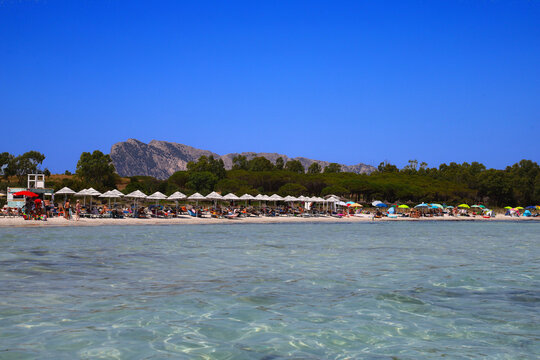 Turquoise sea water and Tavolara Island in Cala Brandinchi Beach in San Teodoro, Sardinia, Italy