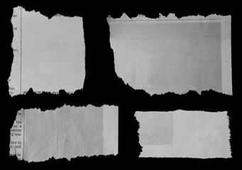 Four pieces of torn newspaper on black background