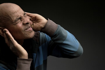 deaf man suffering from deafness and hearing loss on grey background with people stock image stock photo 