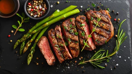 Foto op Plexiglas sliced beef grill steak with green asparagus, dark background © Kateryna Kordubailo