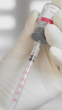 A beautician draws Botox into a syringe for butulin injection. Preparation for a cosmetic procedure in a beauty salon by a professional cosmetologist close-up of the hand
