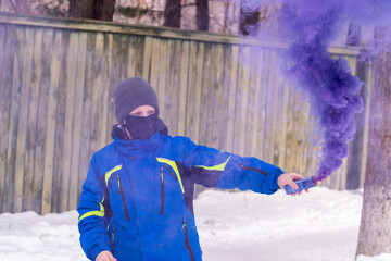 Boy with a stick of colored smoke