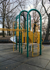 Fototapeta na wymiar children's playground detail with slide and monkey bars (urban park play area with rubber mats, jungle gym for kids) colorful empty toys for children in new york city (brooklyn mount prospect) fun