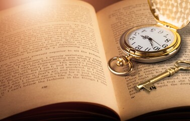 Old vintage retro watch and key on books
