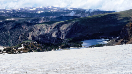 Fototapeta na wymiar Snow activities in Wyoming. Wonderful and only summer ski area. Spectacular view at Beartooth Highway Summit, Wyoming. A Drive of incredible beauty. Yellowstone. Northwest alpine landscape. Road trip.