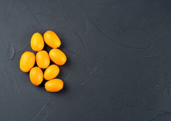 Fresh kumquat fruit on dark background