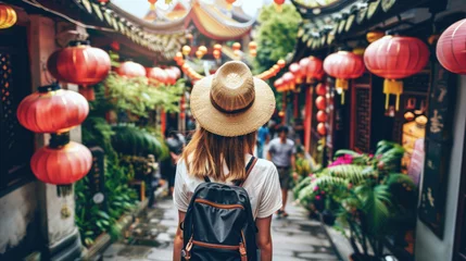 Tuinposter European girl tourist exploring the narrow streets of old cities in Asia © brillianata