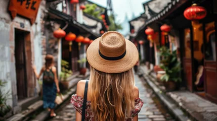 Fotobehang European girl tourist exploring the narrow streets of old cities in Asia © brillianata