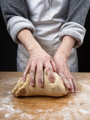 Lifting the front of the dough for the kneading.