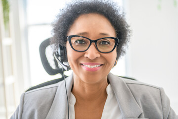 nice Portrait of an black business woman sit at the office with microphone talk to client